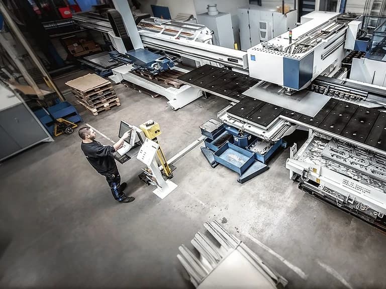 Manufacturing machine operator working at a laser cutting machine
